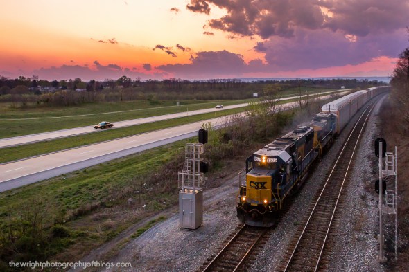 DUSK AT HOBBS: CSX Q216 reaches the summit of the upper Shenandoah Valley at Hobbs on the Cumberland Sub near Bardane, WV on March 28, 2012. Rain clouds loom in the distance as the sun had set over the horizon about ten minutes prior to the trains arrival. The train with CSX SD50 8575 leading runs alongside the West Virginia Route 9 Freeway for a few miles between Kearneysville and Shenandoah Junction. The bridge where this was taken is popular among local railfans as it currently only leads to an orchard the the highway separated when it was built and sees very little use.