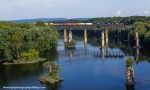 Of the many bridges that span the Potomac River here, only 2 are active. In the foreground are the remains of a prior road bridge that connected Maryland on the left and West Virginia on the right. The higher further piers are what remains of the old Shenandoah Valley Railroad bridge that stood until 1917. Finally, the present and former Norfolk and Western railroad bridge that Norfolk Southern train 13R is seen high above the water. Another bridge stood in the immediate foreground but was totally demolished upon completion of the current&nbsp;road